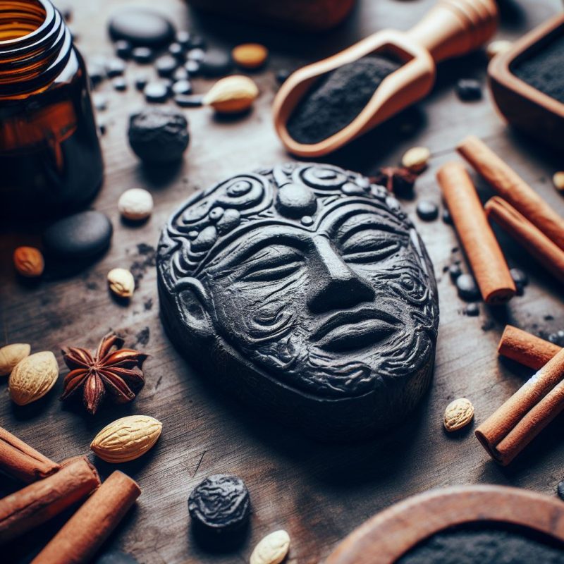 Artistic charcoal carving of a serene face surrounded by cinnamon sticks, almonds, star anise, a glass bottle, and a wooden scoop with dark powder on a rustic background.