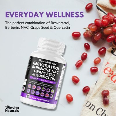 A bottle of Winvita Naturals dietary supplement with Resveratrol, Berberine, NAC, Grape Seed, and Quercetin against a clean background, with fresh red grapes and a towel printed with the word 'eat'.
